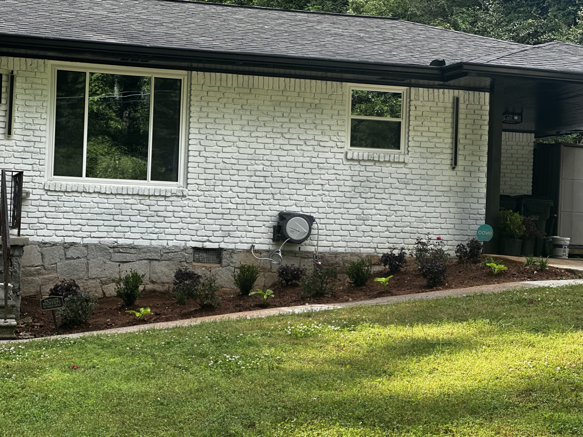 New shrub plantings along brick house